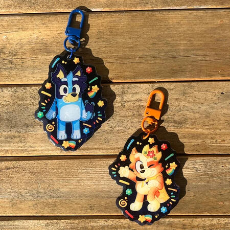 acrylic charms featuring bluey and bingo from the cartoon bluey
