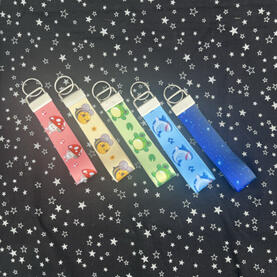 keychains. includes mushroom, bee, frog, shark, and constellation designs.